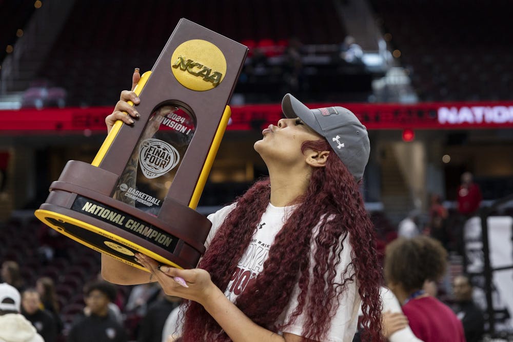 <p>Senior center Kamilla Cardoso blows a kiss on the NCAA champion trophy on the court of Rocket Mortgage FieldHouse on April 8, 2024. Cardoso earned the NCAA Final Four Most Outstanding Player award.</p>