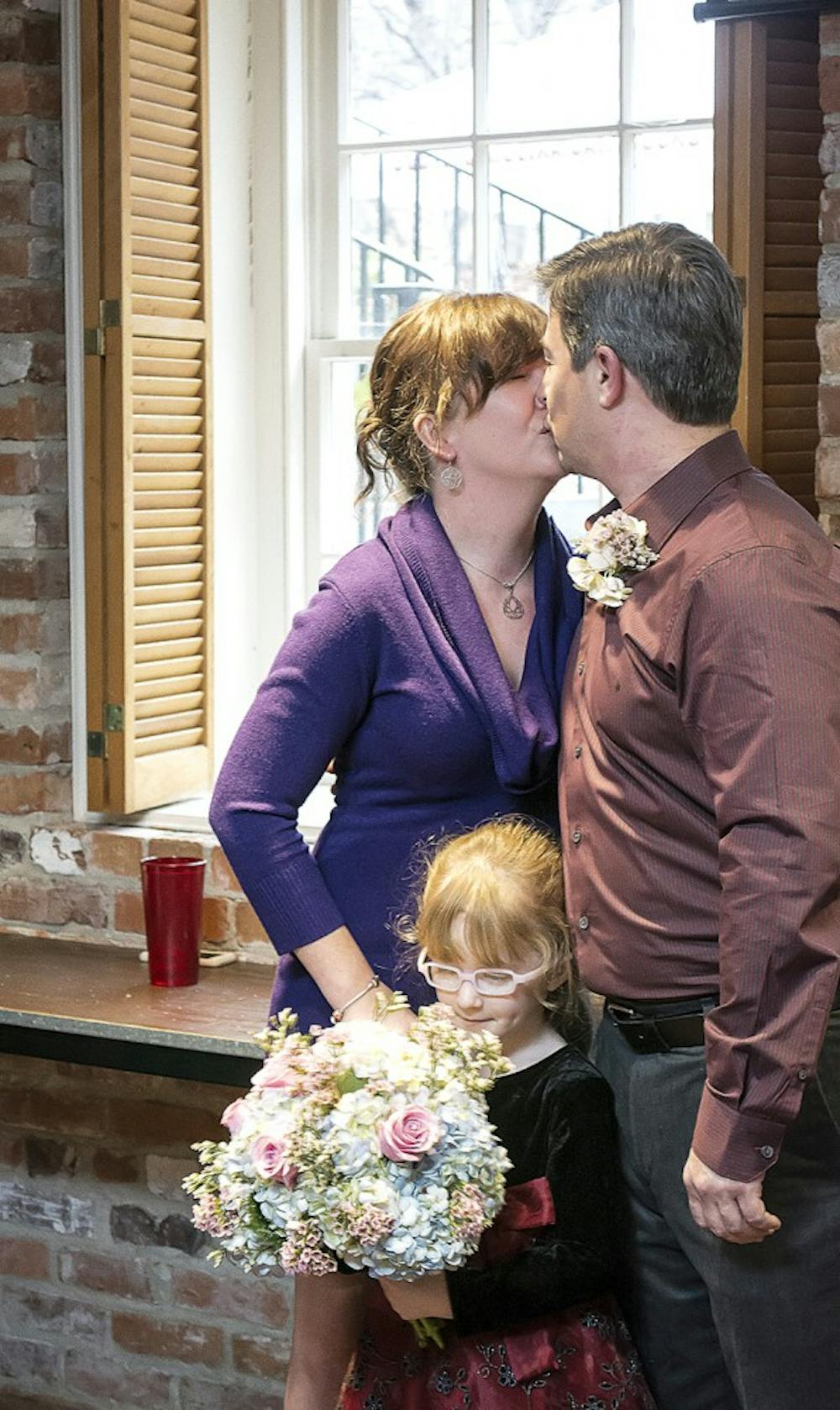 	<p>Erin Stone and Scott Smith celebrate their win with daughter Cameron at the McCutcheon House on Tuesday.</p>