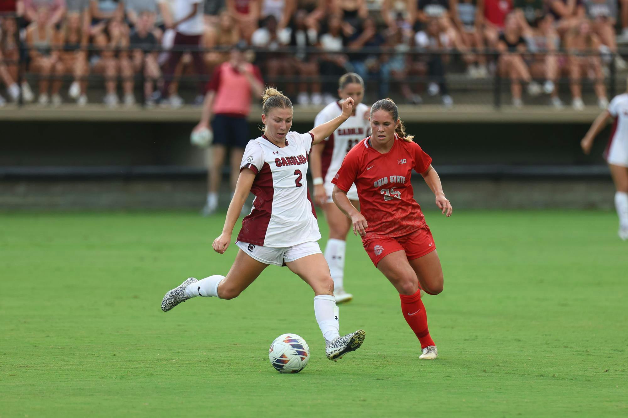 Junior midfielder Maggie Taitano advances the ball against a defending player during the game against Ohio State at Eugene E. Stone III Stadium on Aug. 21, 2025. The Gamecocks defeated the Buckeyes 1-0.
