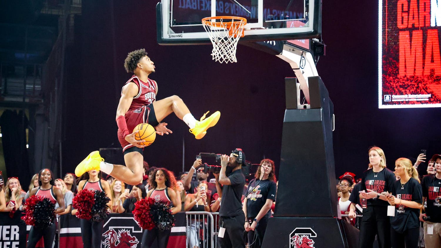 Freshman forward EJ Walker performs a dunk from under his leg during a dunking contest at GarNET & Black Madness on Oct. 21, 2025, at Colonial Life Arena. The contest was judged by members of the women's basketball team and rapper Waka Flocka Flame