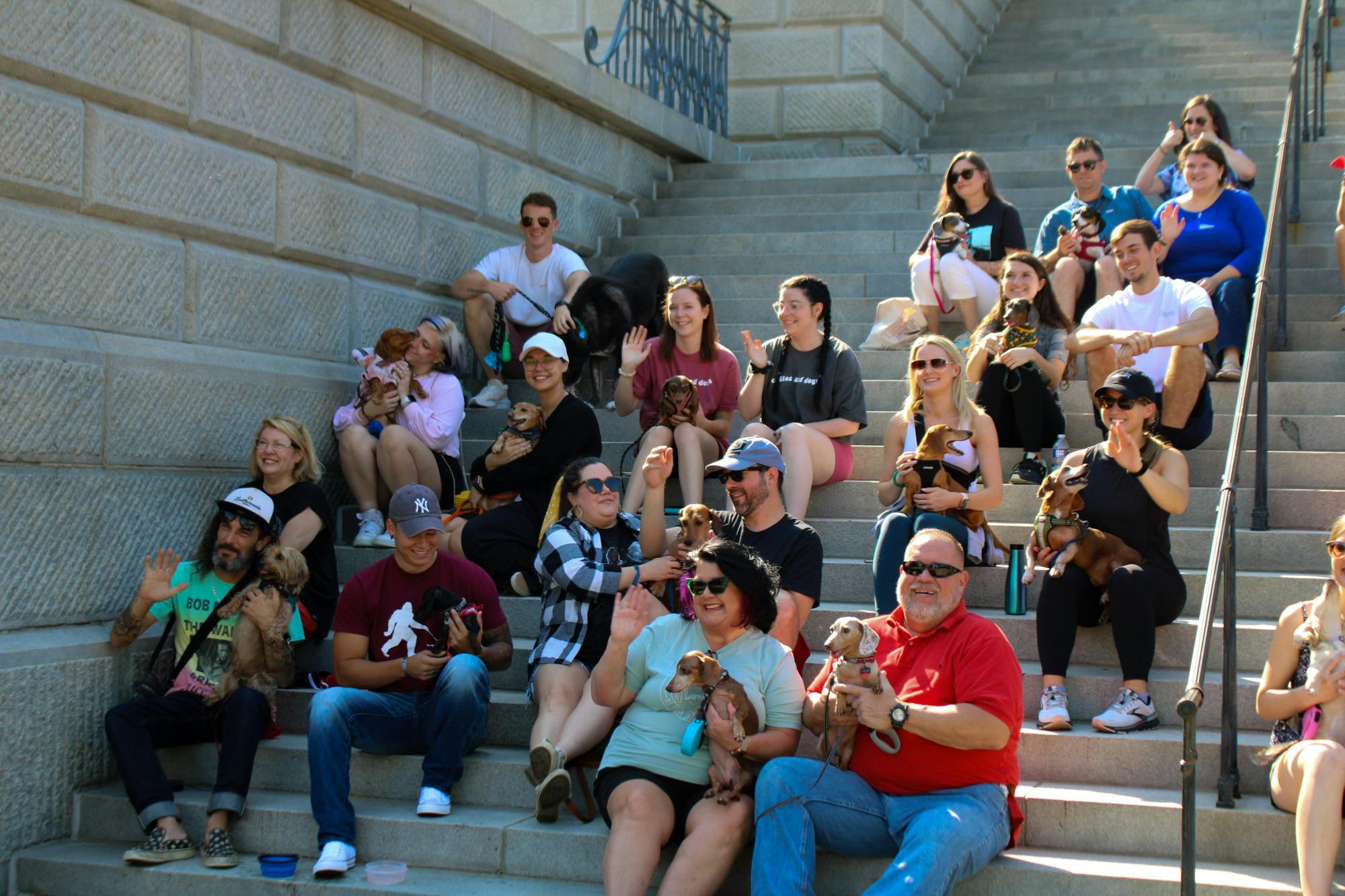 The Dachshunds of Columbia dog walking group gathers along the steps of the Statehouse with their dogs for a group picture on Sept. 17, 2022. The Columbia dog-walking group gathered with their furry friends for a walk from USC's Horseshoe to the S.C. Statehouse.