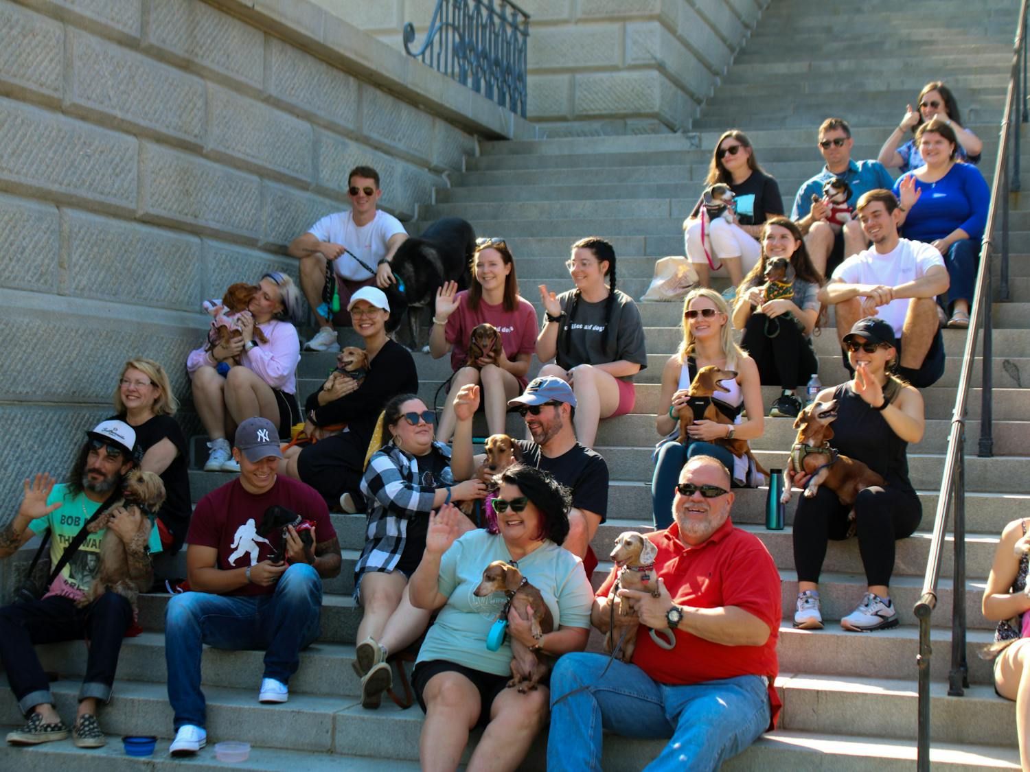 The Dachshunds of Columbia dog walking group gathers along the steps of the Statehouse with their dogs for a group picture on Sept. 17, 2022. The Columbia dog-walking group gathered with their furry friends for a walk from USC's Horseshoe to the S.C. Statehouse.