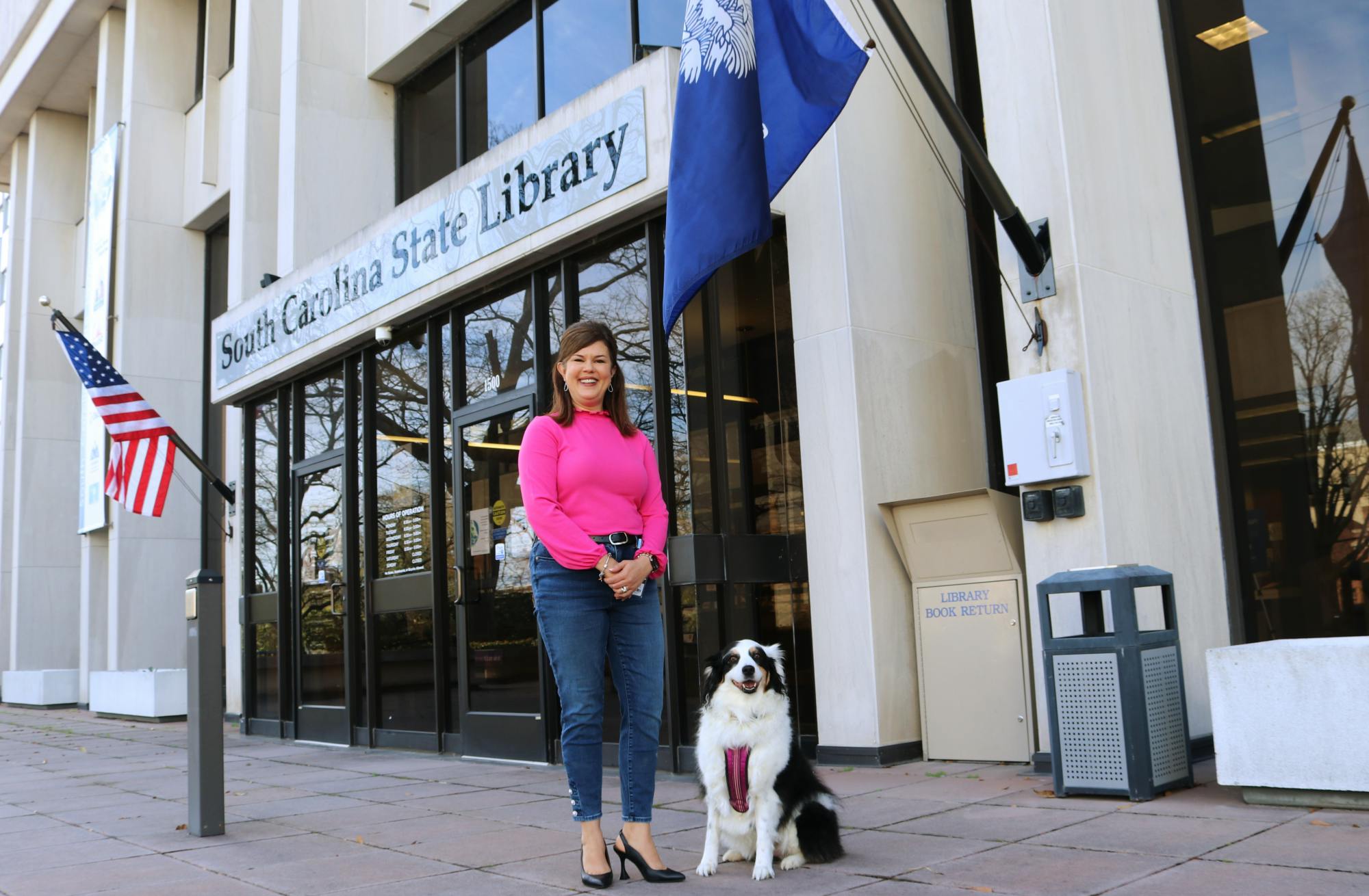 Katie, a 9-year-old Australian shepherd, sits outside of the South Carolina State Library, ready to go for a stroll around town on Feb. 10, 2023. Prior to the COVID-19 pandemic, Katie could be found frequently boosting childrens’ spirits at Prisma Health Baptist Hospital.