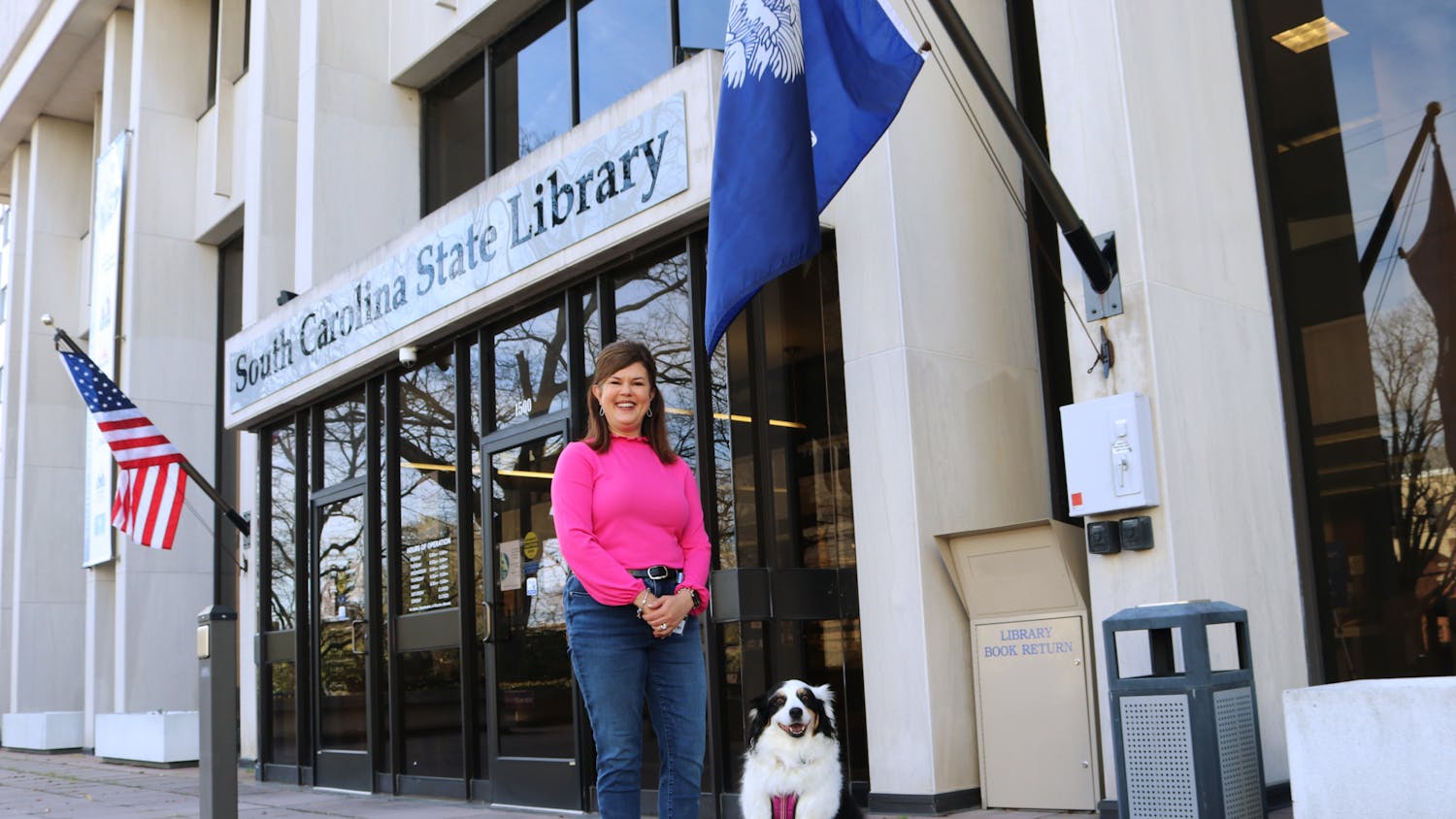 Katie, a 9-year-old Australian shepherd, sits outside of the South Carolina State Library, ready to go for a stroll around town on Feb. 10, 2023. Prior to the COVID-19 pandemic, Katie could be found frequently boosting childrens’ spirits at Prisma Health Baptist Hospital.