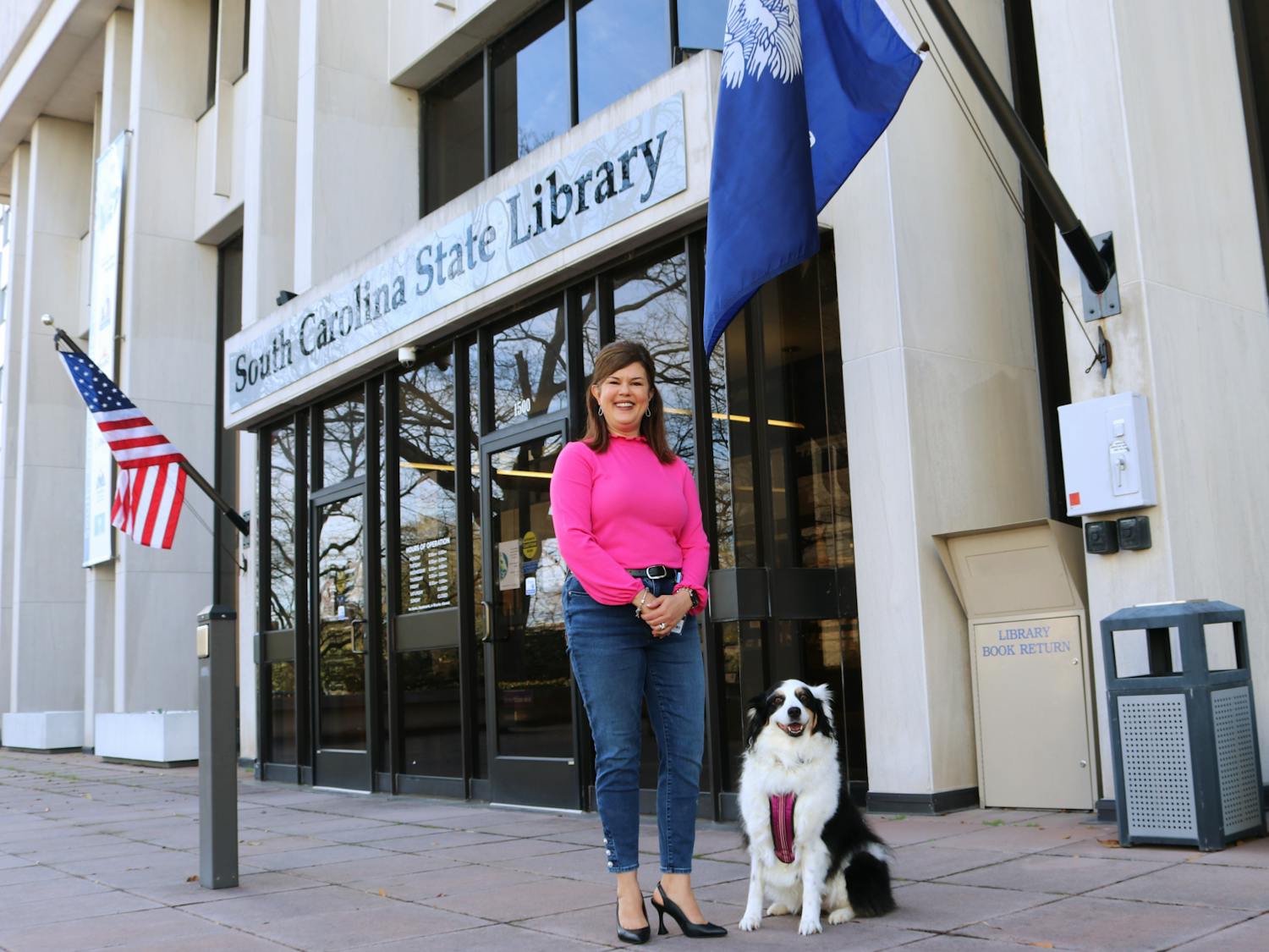 Katie, a 9-year-old Australian shepherd, sits outside of the South Carolina State Library, ready to go for a stroll around town on Feb. 10, 2023. Prior to the COVID-19 pandemic, Katie could be found frequently boosting childrens’ spirits at Prisma Health Baptist Hospital.