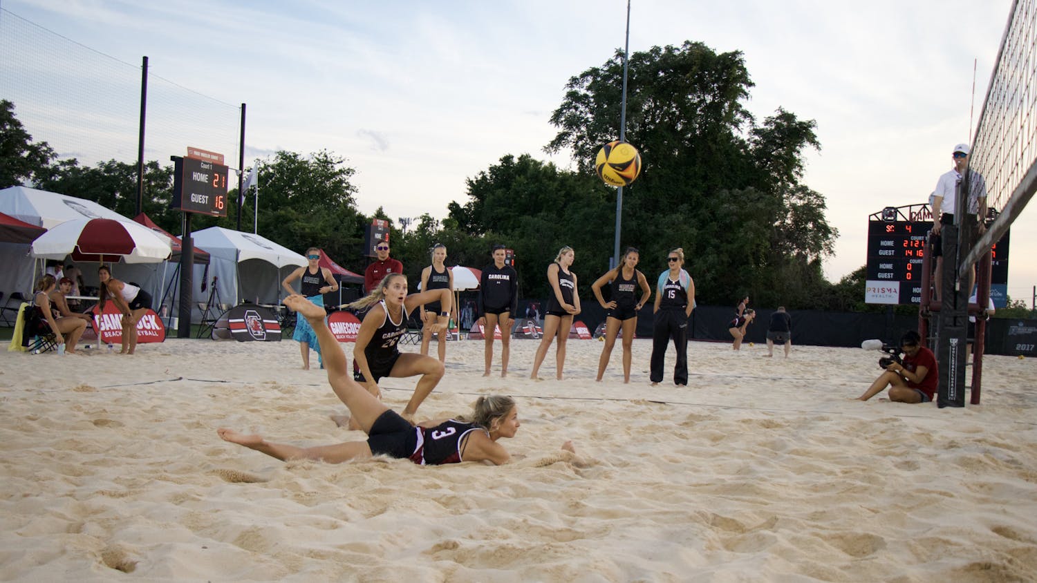 Senior Hailey Cabeceiras dives on the ground with her teammate freshman Presley Wright on April 15, 2023, at Wheeler Beach. In 2022, Cabeceiras posted an overall record of 6-4. 
