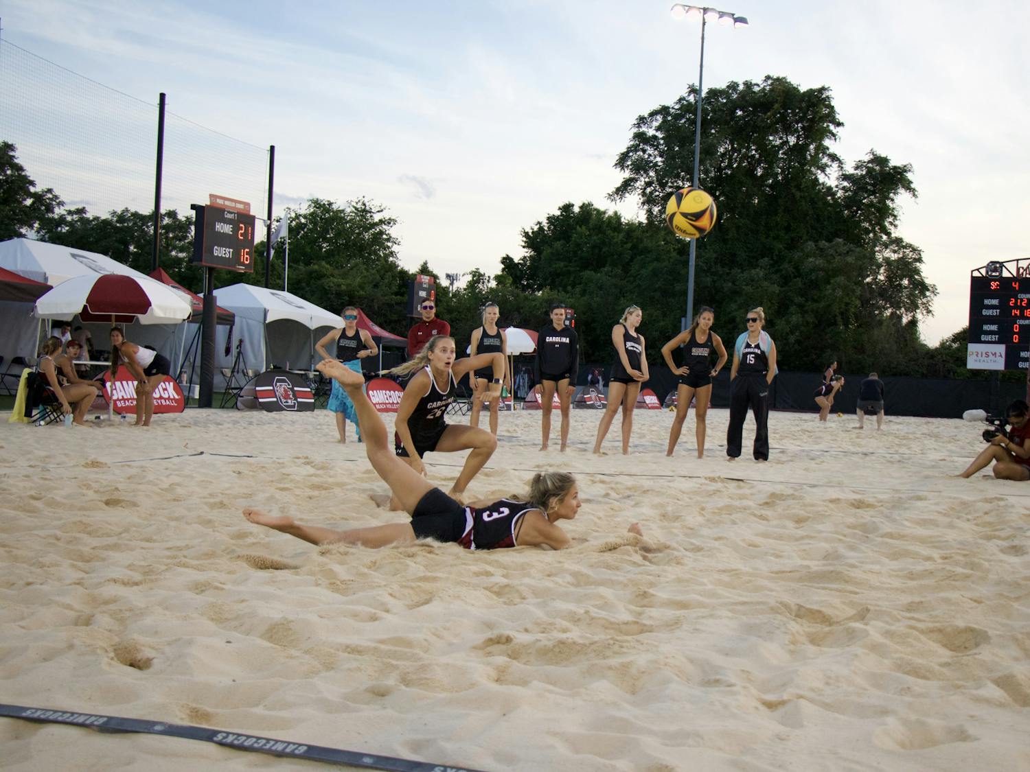 Senior Hailey Cabeceiras dives on the ground with her teammate freshman Presley Wright on April 15, 2023, at Wheeler Beach. In 2022, Cabeceiras posted an overall record of 6-4. 