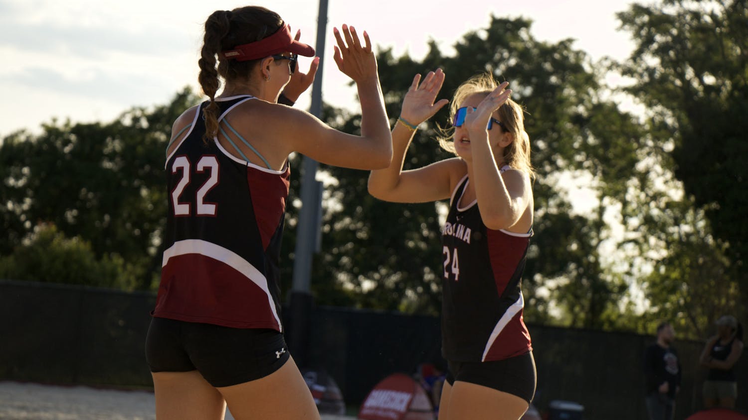 Graduate student Allison Coens and sophomore Lauren Wilcock share a high five after scoring on April 15, 2023, at Wheeler Beach. Wilcock was on the 2022 CCSA All-Freshman Team.&nbsp; &nbsp;