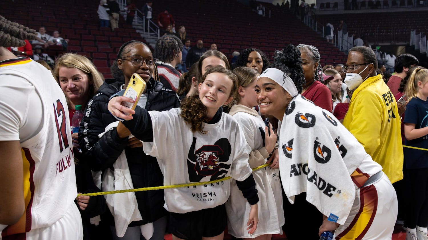 Senior Guard Te-Hina Paopao poses for a selfie with a young fan after the Gamecock 83-65 victory over the Huskies on Feb. 11, 2024. Colonial Life Arena was sold out for the ranked match-up.