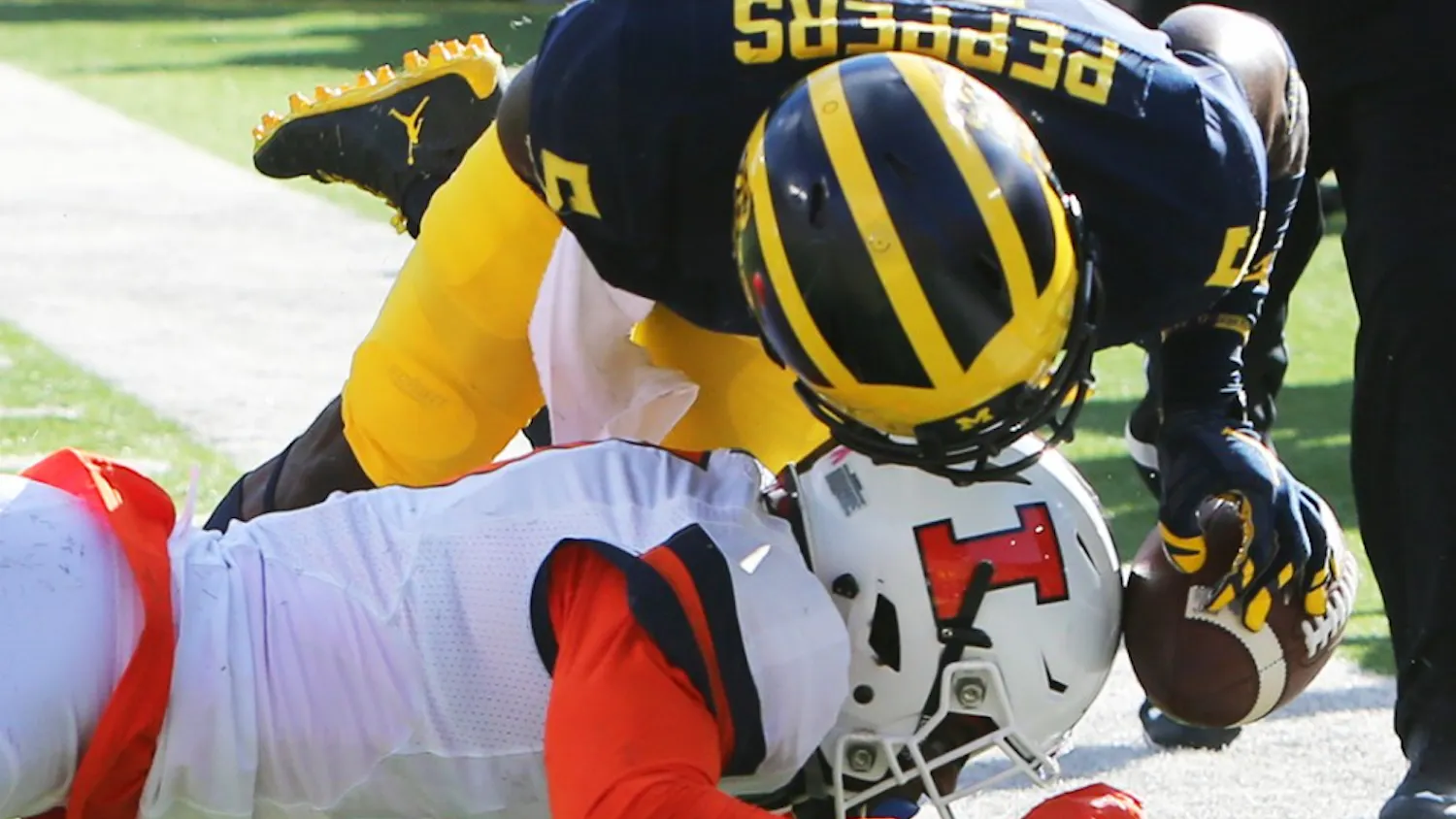 Michigan's Jabrill Peppers (5) is tackled by Illinois' Stanley Green in the first quarter on Saturday, Oct. 22, 2016, at Michigan Stadium in Ann Arbor, Mich. The host Wolverines won, 41-8. (Kirthmon F. Dozier/Detroit Free Press/TNS)