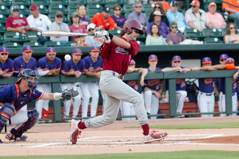 <p>FILE—Fifth-year outfielder Brandt Belk swings and runs a single during a game on March 5, 2022. The Gamecocks fell 10-2 in the second game of the series against Clemson.</p>
