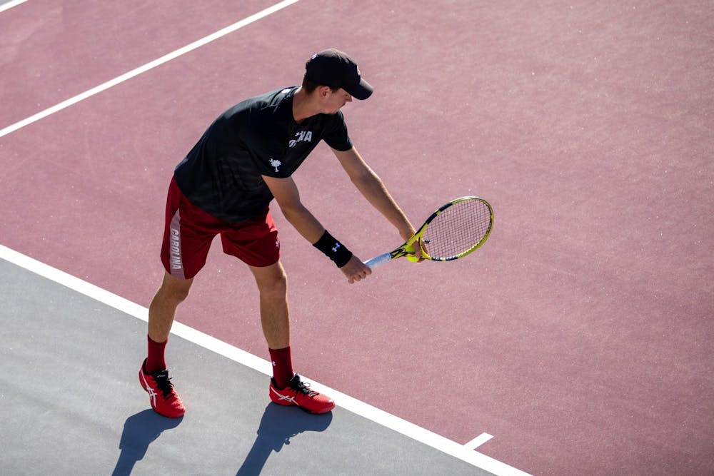 FILE—Junior Raphael Lambling prepares to serve to his opponent during a match on October 31, 2021. The Gamecocks beat LSU 4-1 on January 29, 2022 in Columbia, SC.