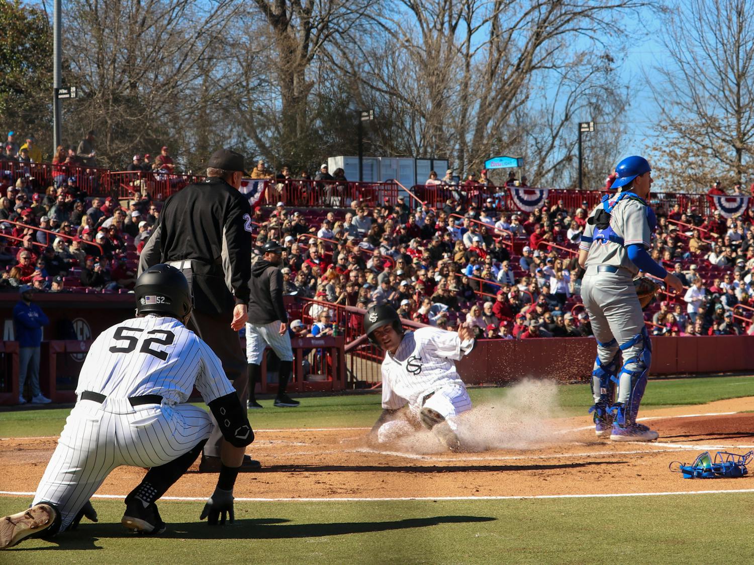 Junior first baseman Gavin Casas slides into home after hitting back-to-back home runs with fifth-year infielder Will McGillis in the fifth inning on Feb. 18, 2023. The Gamecocks hit back-to-back homeruns in both of its opening games this season. &nbsp;