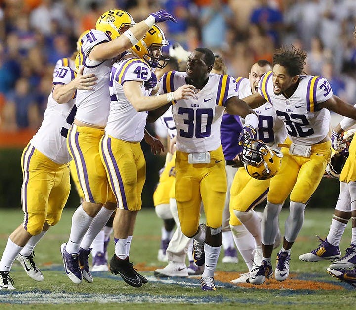 LSU players mob kicker Colby Delahoussaye (42) after he kicked a last-second 50-yard field goal against Florida at Ben Hill Griffin Stadium in Gainesville, Fla., on Saturday, Oct. 11, 2014. LSU won, 30-27. (Stephen M. Dowell/Orlando Sentinel/MCT)