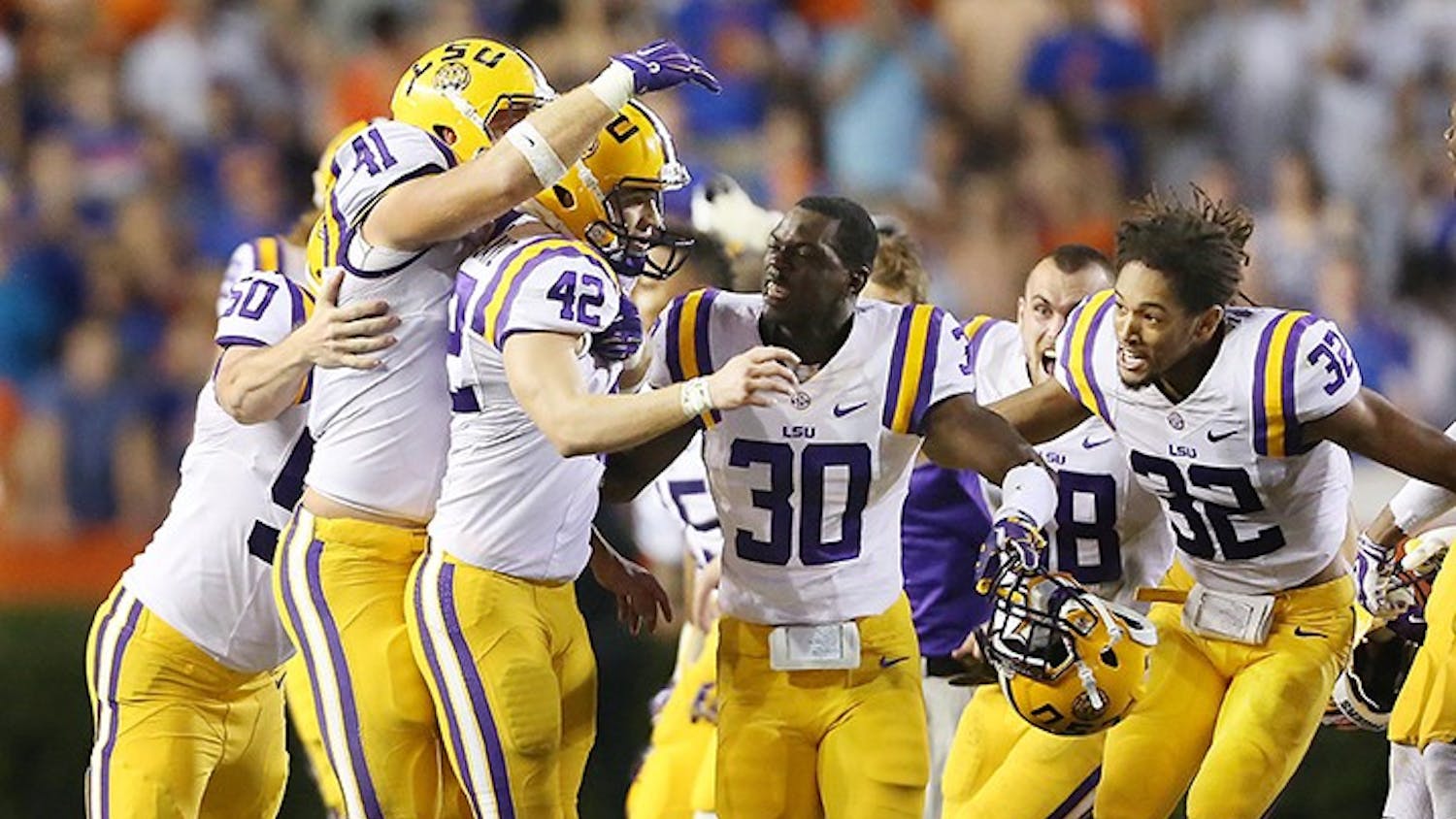 LSU players mob kicker Colby Delahoussaye (42) after he kicked a last-second 50-yard field goal against Florida at Ben Hill Griffin Stadium in Gainesville, Fla., on Saturday, Oct. 11, 2014. LSU won, 30-27. (Stephen M. Dowell/Orlando Sentinel/MCT)
