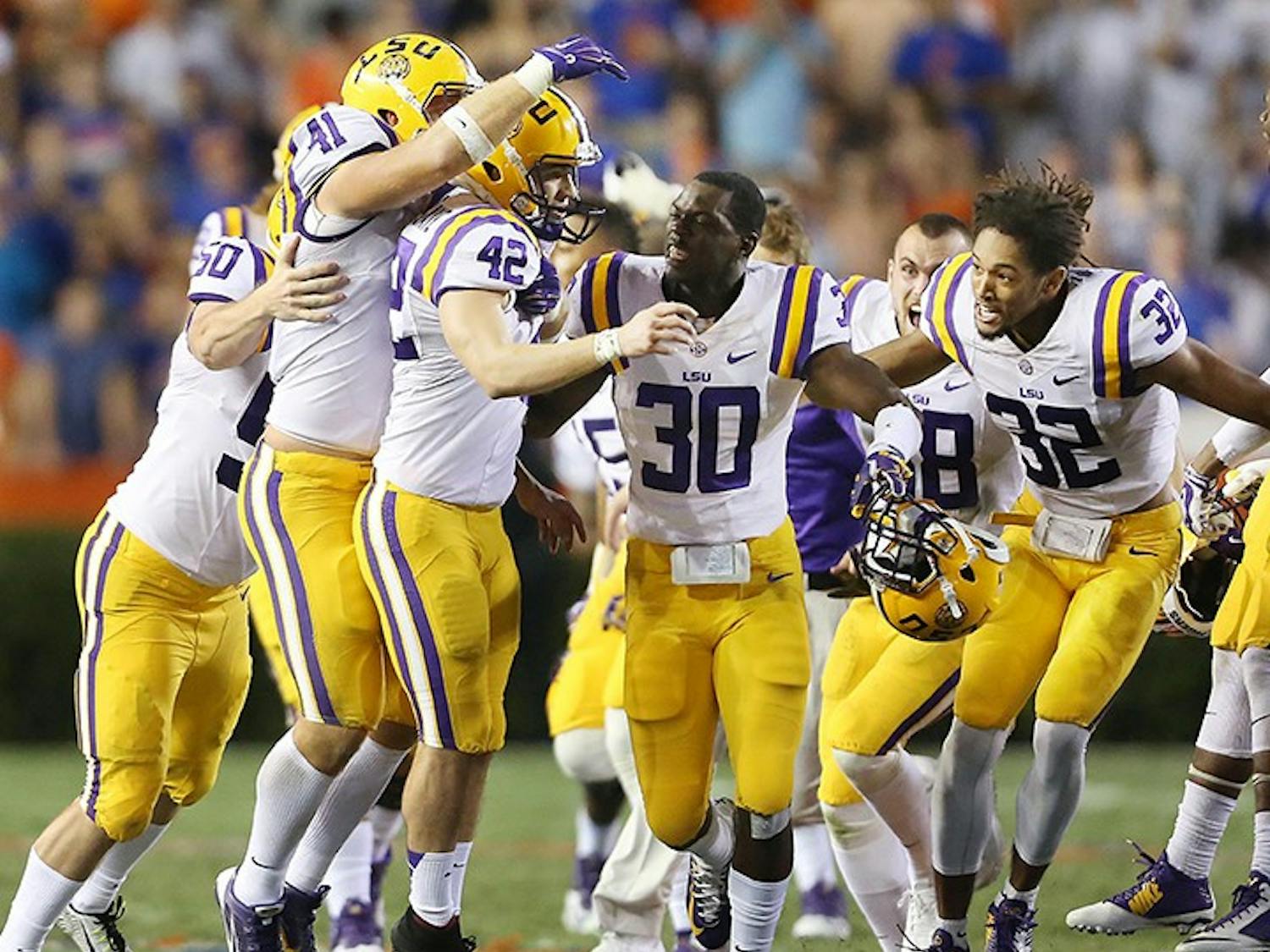 LSU players mob kicker Colby Delahoussaye (42) after he kicked a last-second 50-yard field goal against Florida at Ben Hill Griffin Stadium in Gainesville, Fla., on Saturday, Oct. 11, 2014. LSU won, 30-27. (Stephen M. Dowell/Orlando Sentinel/MCT)