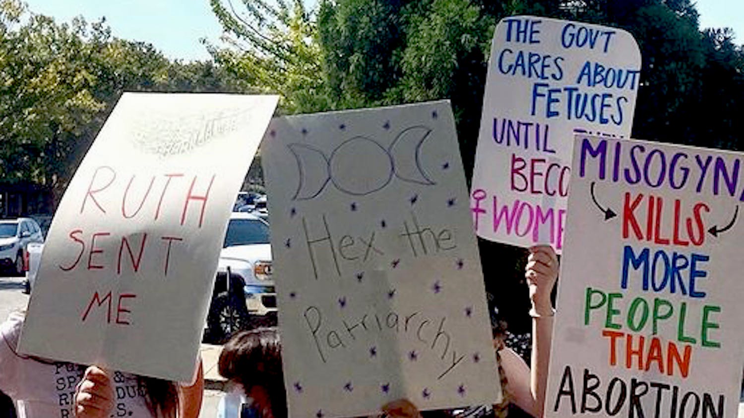 Members of the American Civil Liberties Union (ACLU) Columbia executive board hold up signs as they attend a women's reproductive rights march. ACLU Columbia said it hopes to create a safe space for those to share ideas and opinions on different individual rights and civil liberty topics.