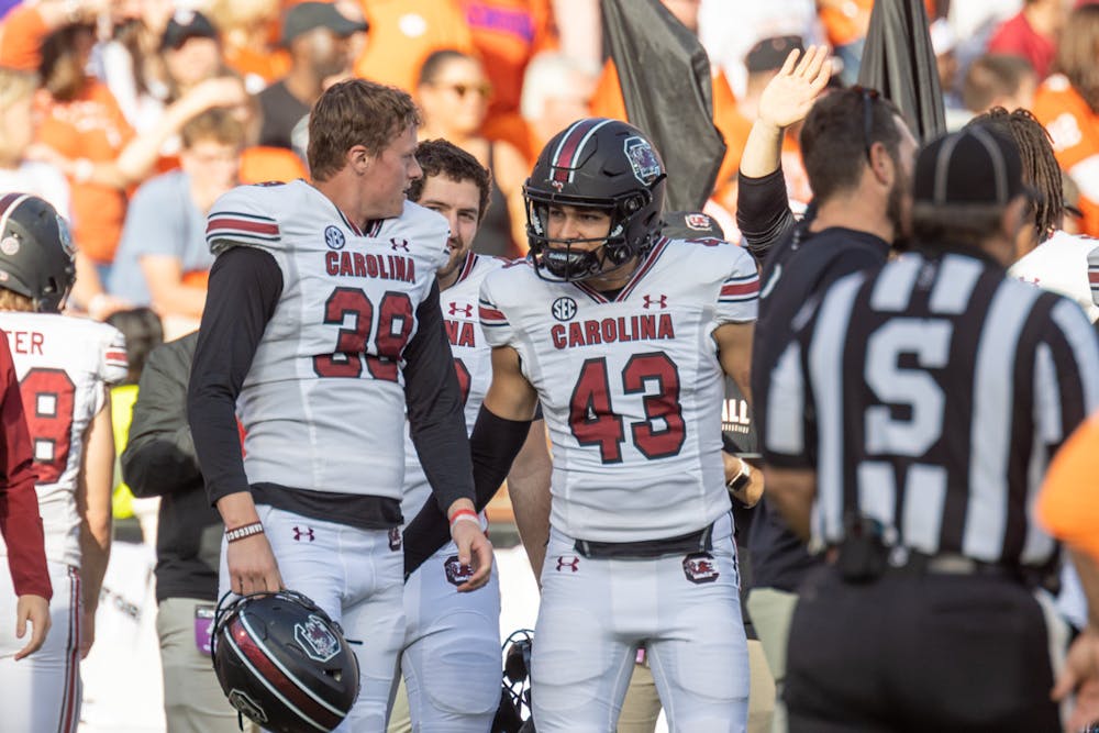 Junior punter Kai Kroeger discussing with redshirt freshman Joseph Byrnes during a timeout on Nov. 26, 2022 at Memorial Stadium. Kroeger punted a total of 376 yards against Clemson.
