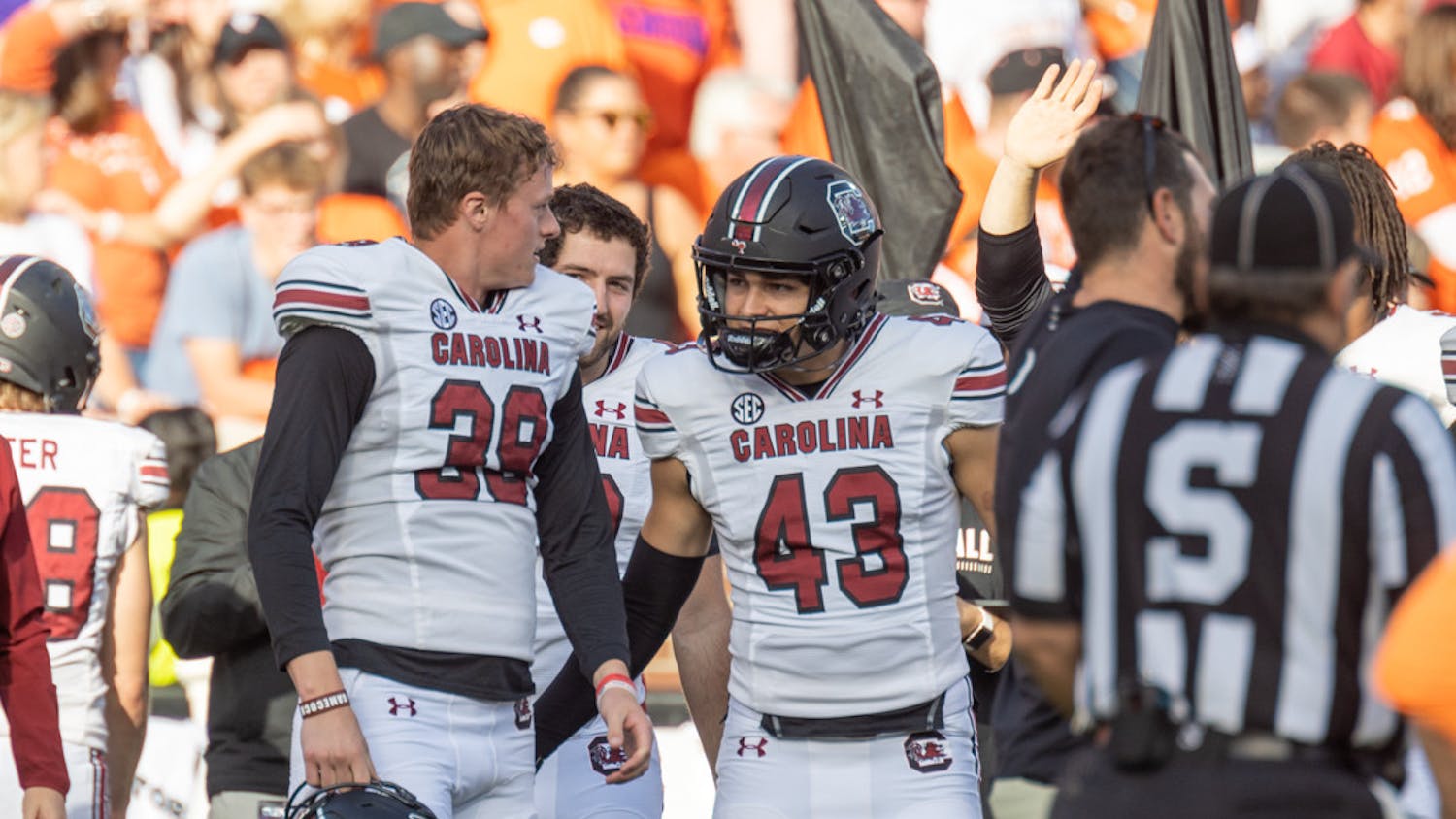 Junior punter Kai Kroeger discussing with redshirt freshman Joseph Byrnes during a timeout on Nov. 26, 2022 at Memorial Stadium. Kroeger punted a total of 376 yards against Clemson.