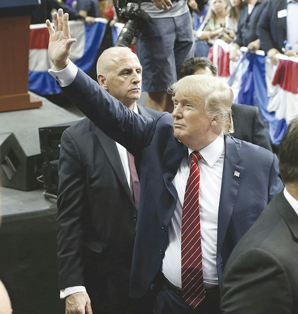 Republican presidential candidate Donald Trump waves to the crowd as he leaves after his speech at American Airlines Center in Dallas on Monday, Sept. 14, 2015. (Nathan Hunsinger/Dallas Morning News/TNS)