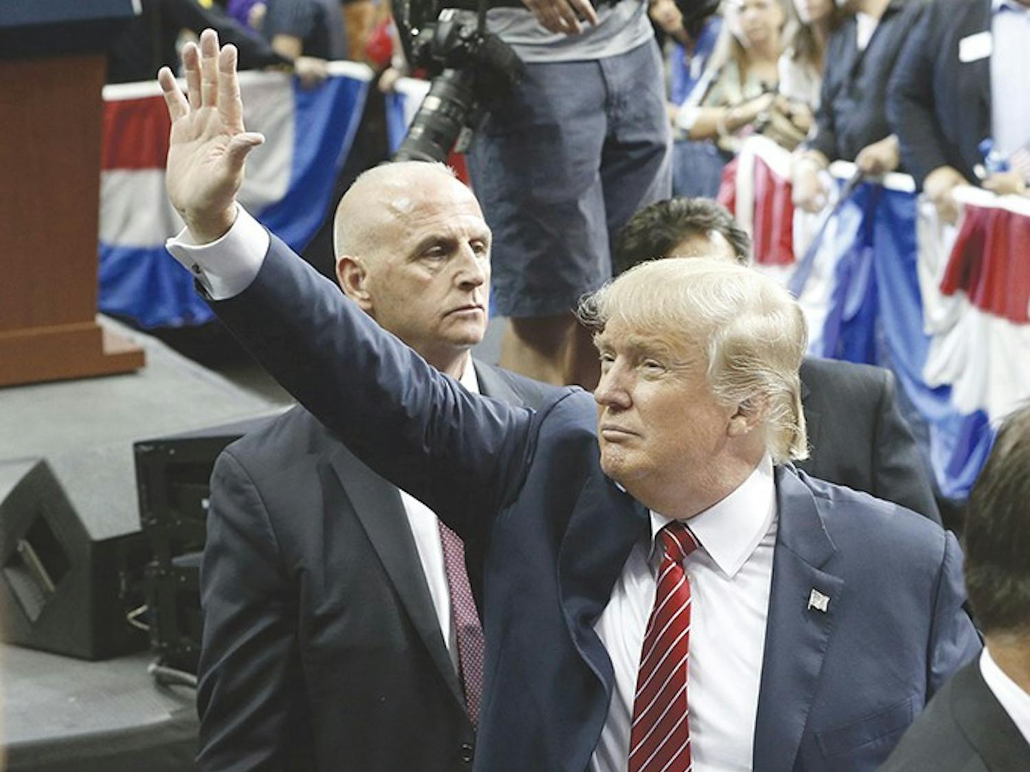 Republican presidential candidate Donald Trump waves to the crowd as he leaves after his speech at American Airlines Center in Dallas on Monday, Sept. 14, 2015. (Nathan Hunsinger/Dallas Morning News/TNS)