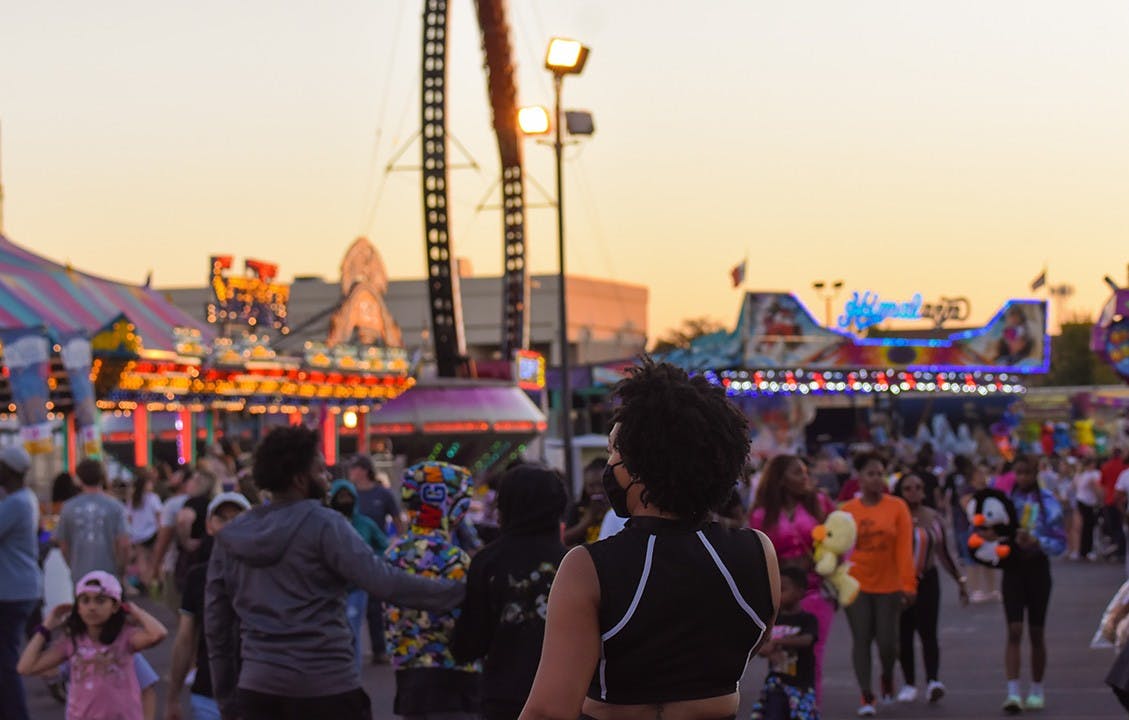 A woman walks through the fairgrounds.&nbsp;