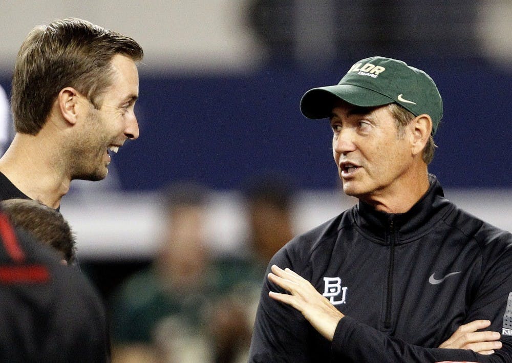 Head Coach Kliff Kingbury, left, of the Texas Tech Red Raiders and Head Coach Art Briles of the Baylor Bears meet on the field before their game at AT&T Stadium in Arlington, Texas, on Saturday, November 16, 2013. (Ron Jenkins/Fort Worth Star-Telegram/MCT)