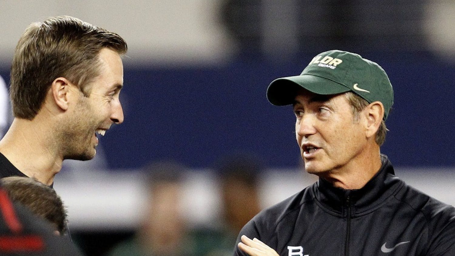 Head Coach Kliff Kingbury, left, of the Texas Tech Red Raiders and Head Coach Art Briles of the Baylor Bears meet on the field before their game at AT&T Stadium in Arlington, Texas, on Saturday, November 16, 2013. (Ron Jenkins/Fort Worth Star-Telegram/MCT)
