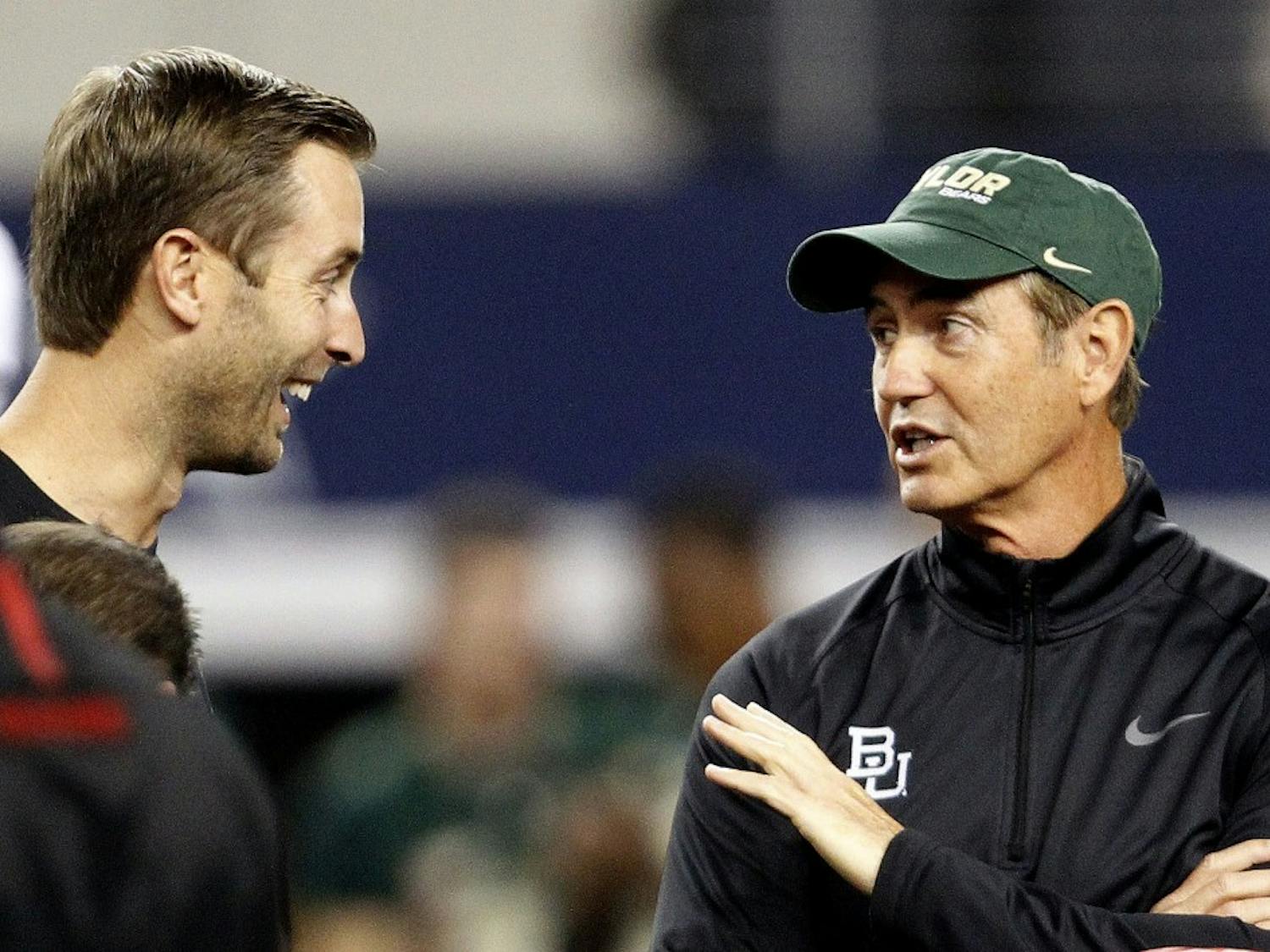Head Coach Kliff Kingbury, left, of the Texas Tech Red Raiders and Head Coach Art Briles of the Baylor Bears meet on the field before their game at AT&T Stadium in Arlington, Texas, on Saturday, November 16, 2013. (Ron Jenkins/Fort Worth Star-Telegram/MCT)