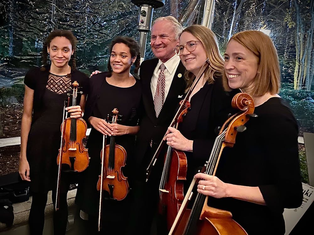 <p>Two students at the Suzuki Academy of Columbia stand with Gov. Henry McMaster (center), violin instructor Kristen Harris (second from right) and academy director Sarah Evanovich (right) stand together at a SoundBites fundraising event in December 2021. SoundBites is a nonprofit based in South Carolina that is dedicated to providing high-quality instruments to those who cannot afford them.</p>