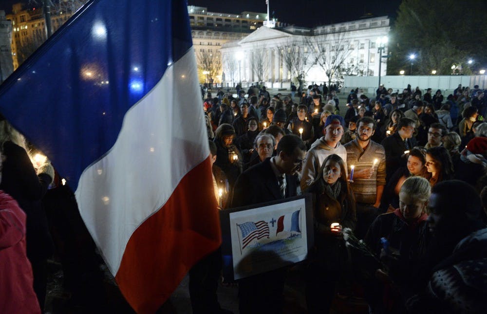 A crowd gathers for a vigil in honor of the victims of terrorist attacks in Paris at Lafayette Square, outside the White House, on Saturday, Nov. 14, 2015, in Washington, D.C. People gathered in cities around the world to show support for Paris following the coordinated assault that left at least 129 people killed and more than 350 injured. (Olivier Douliery/Abaca Press/TNS)