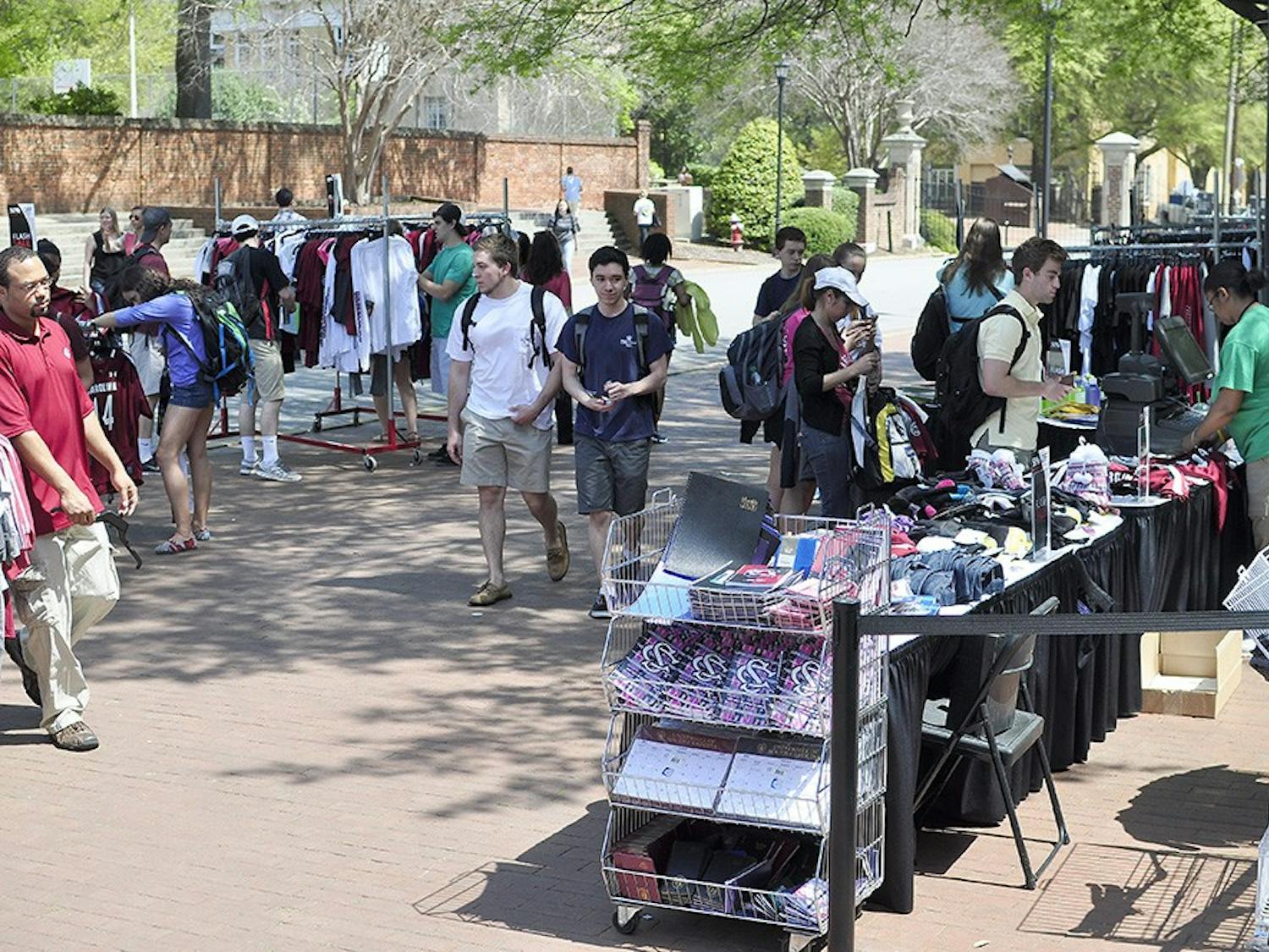Members of the USC Fashion Board sell T-shirts and hair ties designed by students, as well as tickets to Thursday’s fashion show on Greene Street Monday.