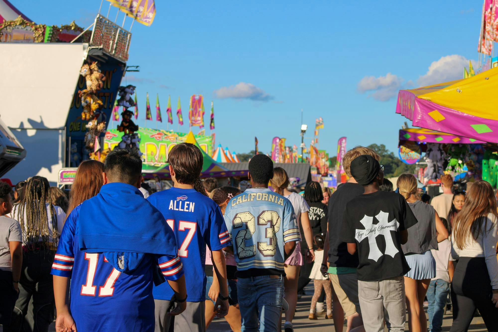 A group of people walk through "Rosewood Lane" at the South Carolina State Fair in Columbia, South Carolina on Oct. 13, 2025. The fair is running from Oct. 8 to Oct. 19 and is located across from Williams-Brice Stadium.