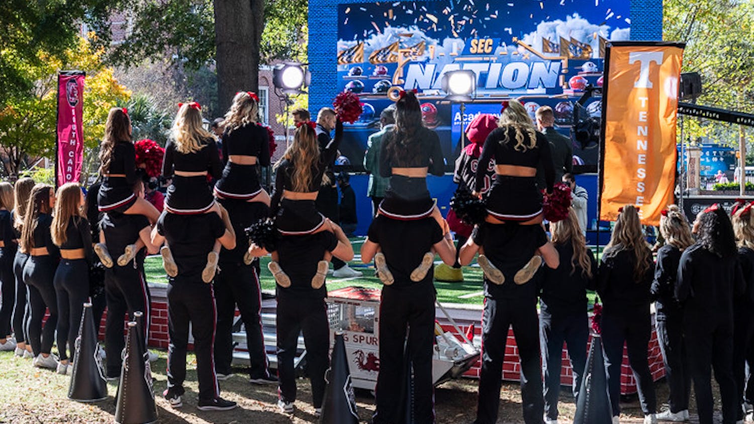 The USC cheer team poses in front of the SEC Nation stage on Nov. 19, 2022. The show covers teams from across the SEC and interviews key coaches and players.