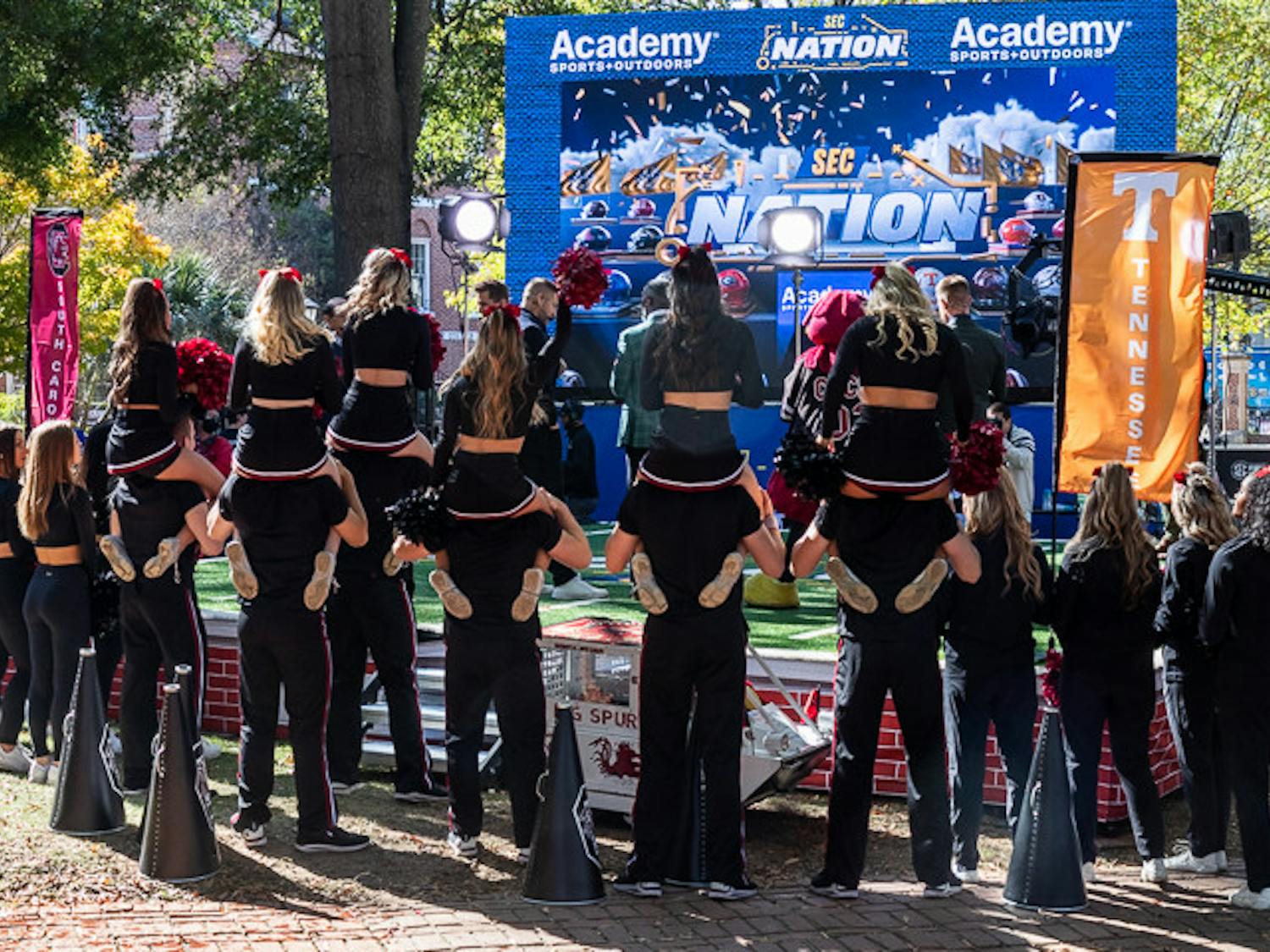 The USC cheer team poses in front of the SEC Nation stage on Nov. 19, 2022. The show covers teams from across the SEC and interviews key coaches and players.