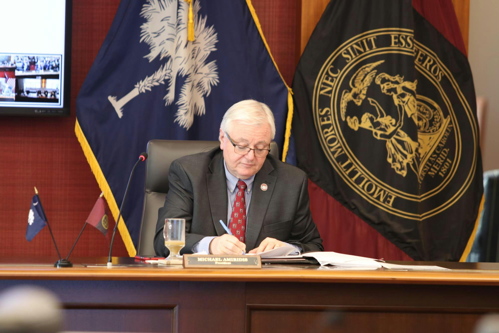 FILE – University of South Carolina President Michael Amiridis takes notes during a board of trustees meeting on March 18, 2024. Amiridis is serving as the university’s 30th president.