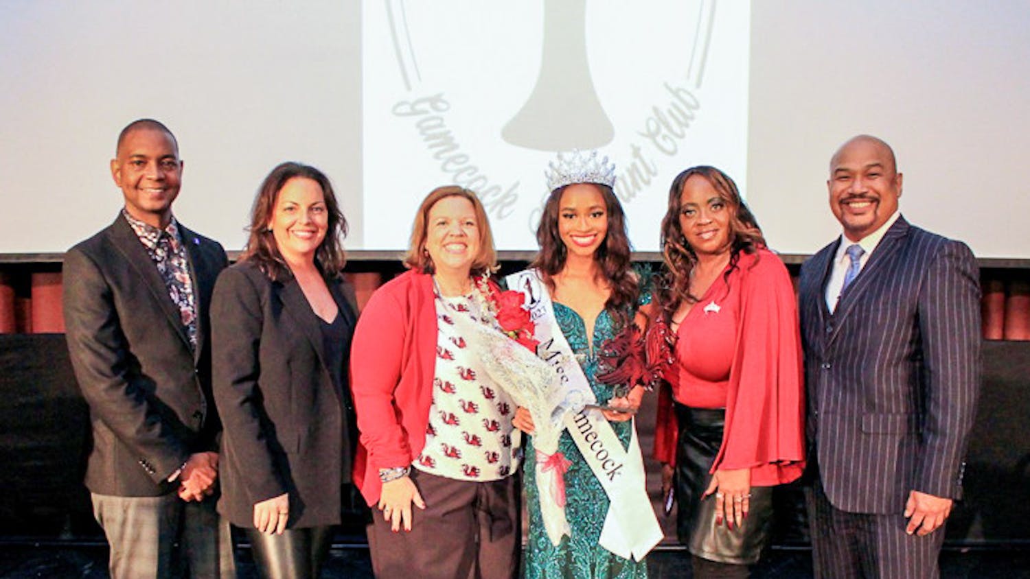 Third-year retail student Jordyn Lewis (center, right) stands amongst judges after winning the Miss Gamecock pageant on Nov. 12, 2022. This was Lewis' first time entering the pageant, and she is the second Black woman to win the contest in USC history.