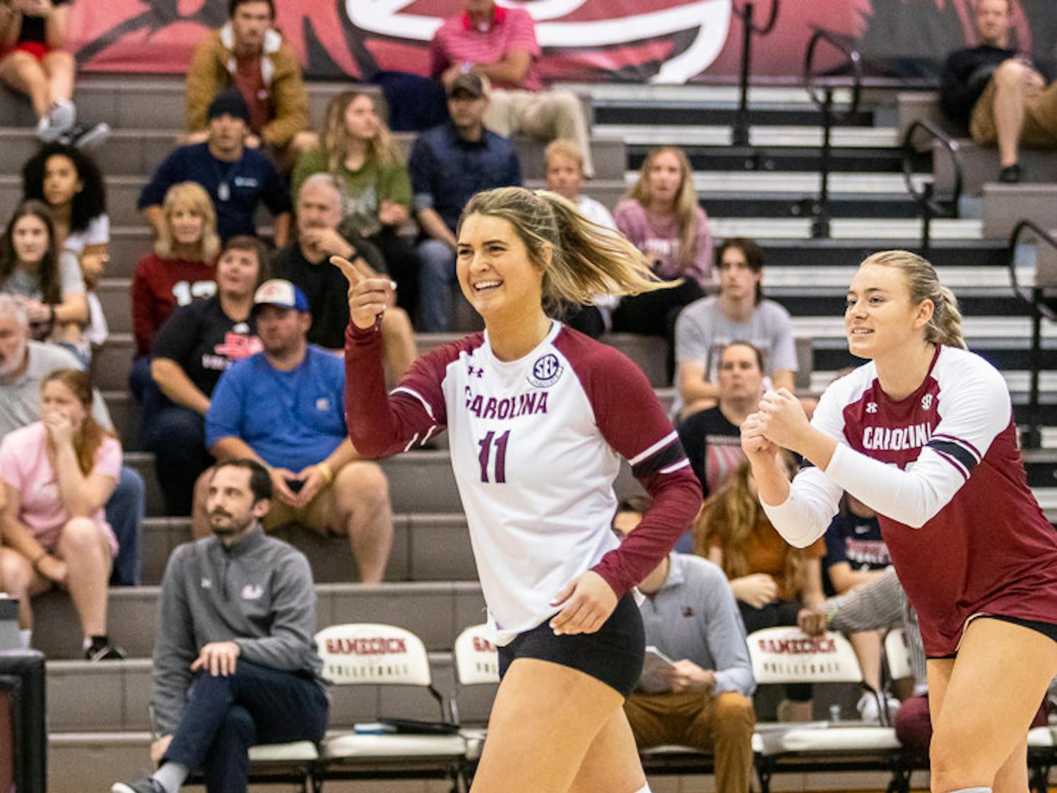 Graduate libero Jenna Hampton and junior outside hitter Riley Whitesides celebrate with their teammates after a successful rally on Nov. 6, 2022. The Gamecocks defeated the Ole Miss Rebels 3-1.&nbsp;