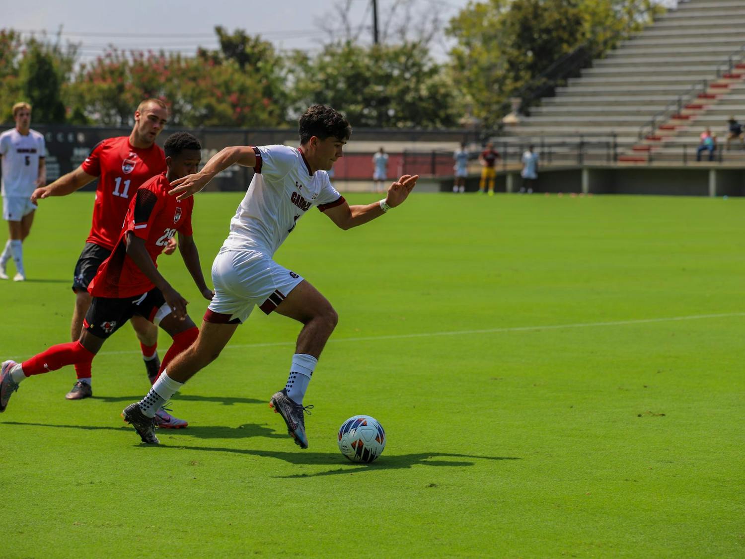 Sophomore midfielder Rocky Perez pushes the ball down the field during the match against Gardner-Webb on Aug. 27, 2023. The Gamecocks totaled 12 shots during the game, but only three shots on goal.