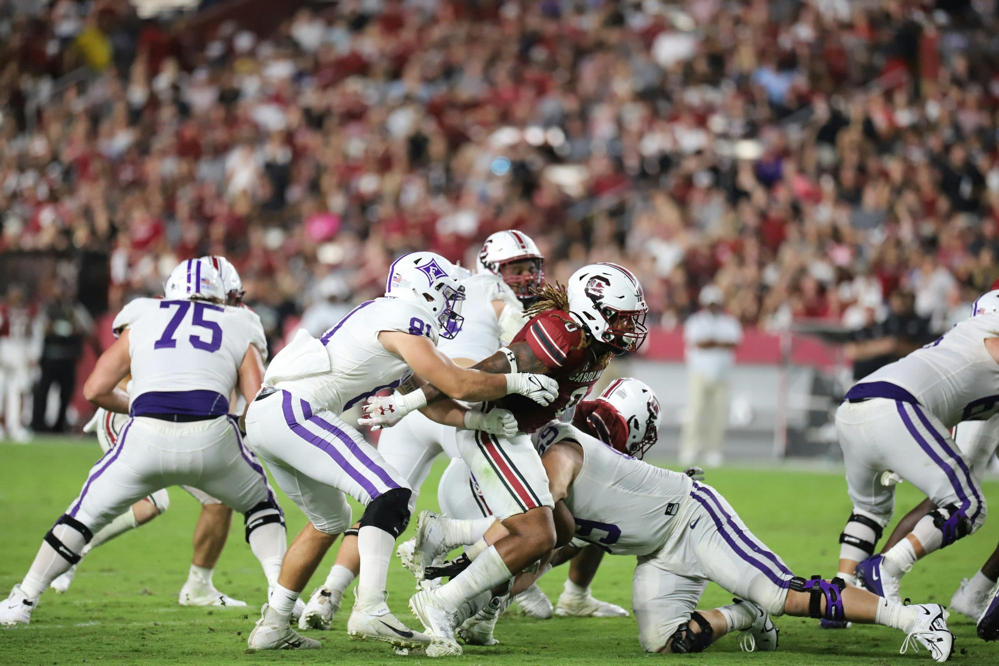 Redshirt junior linebacker Debo Williams pushes through Furman's offensive line into the backfield. Williams was third on the team with four total tackles in his fourth career start.