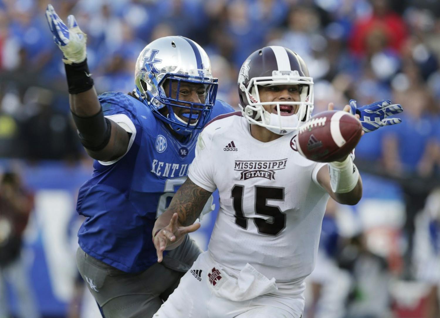 Mississippi State quarterback Dak Prescott (15) makes a lateral pass as Kentucky's Alvin Dupree (2) triesto sack him in the third quarter of the Mississippi State at Kentucky at Commonwealth Stadium in Lexington, Ky., on Oct. 25, 2014. Miss. St. won 45-31. (Pablo Alcala/Lexington Herald-Leader/MCT) 