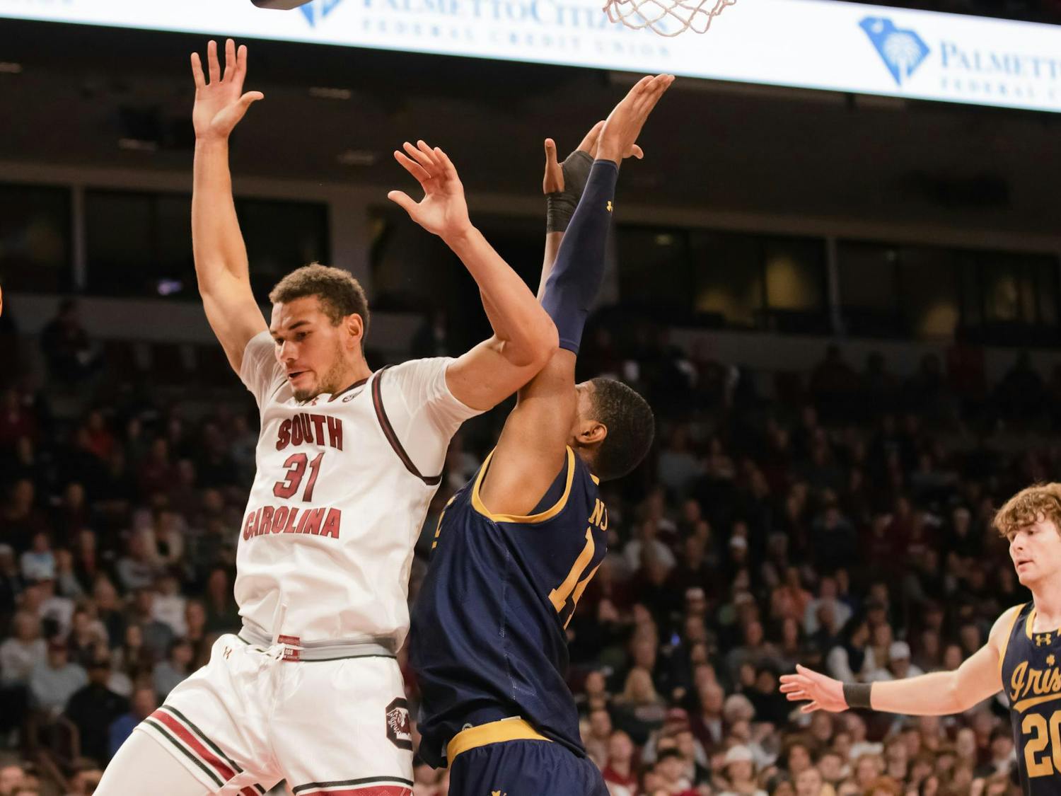 Redshirt senior forward Bejamin Bosmans-Verdonk collides at the net with a Notre Dame player during a game on Nov. 28, 2023. The Gamecocks beat the Fighting Irish 65-53.