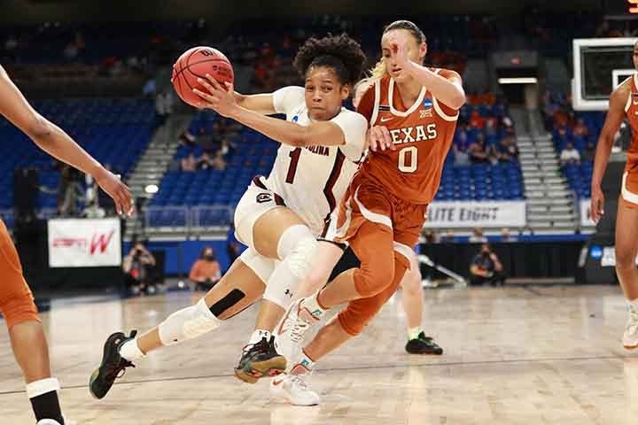 Sophomore guard Zia Cooke runs and dribbles between two Longhorn players. The Gamecocks beat the Longhorns 62-34, letting them advance to the Final Four.