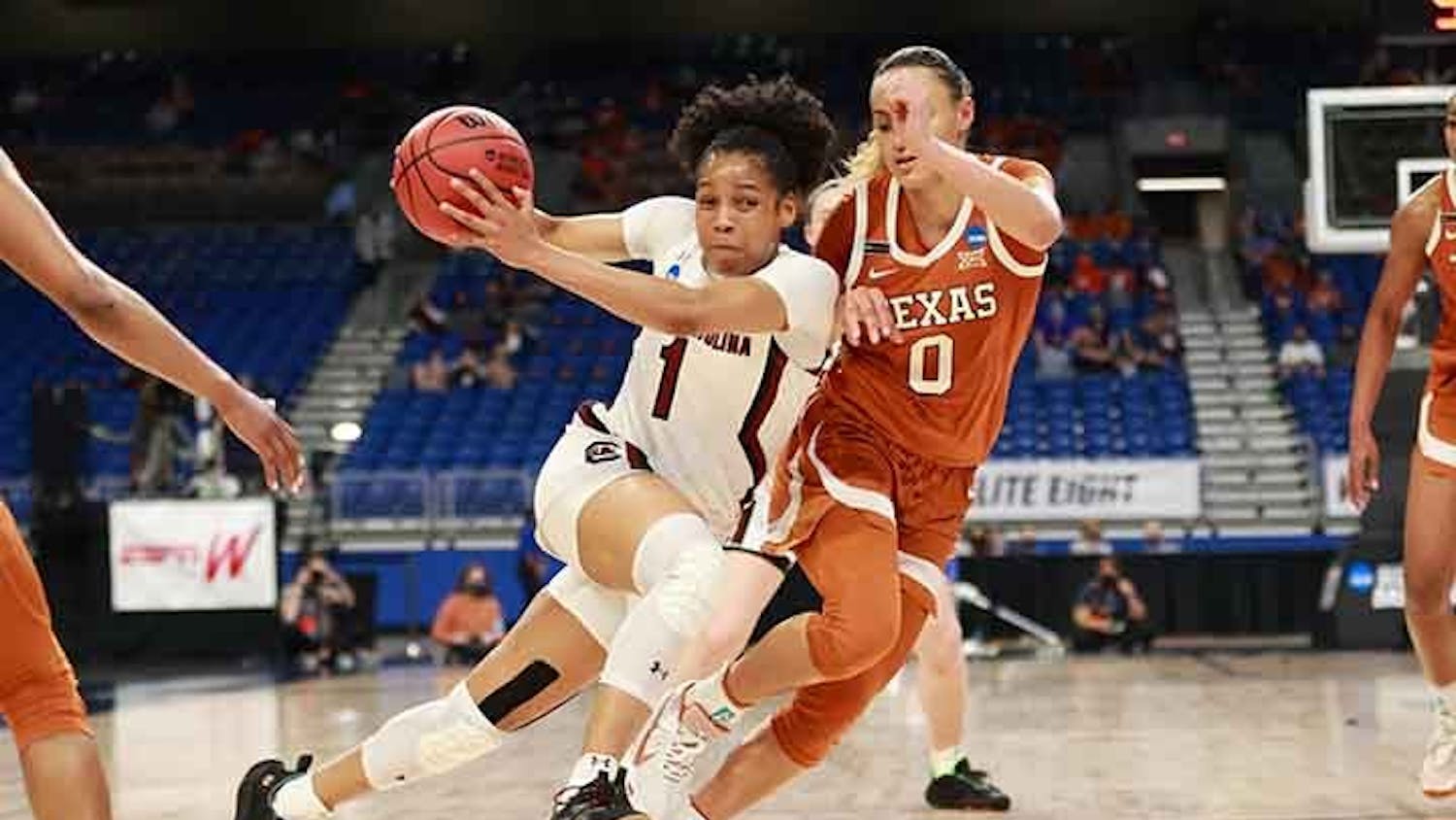 Sophomore guard Zia Cooke runs and dribbles between two Longhorn players. The Gamecocks beat the Longhorns 62-34, letting them advance to the Final Four.