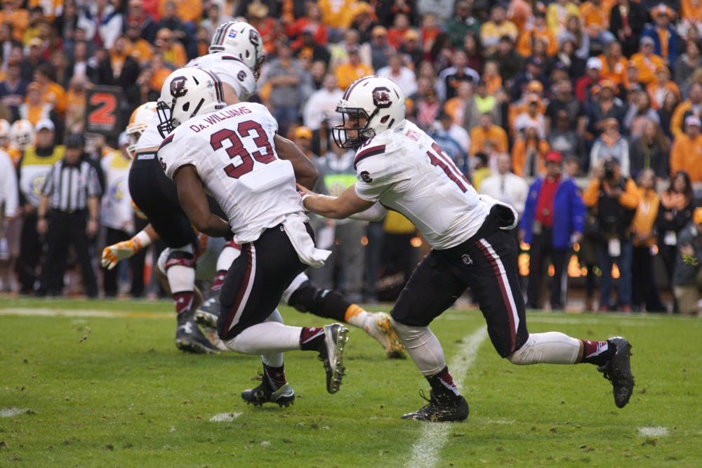 David Williams takes a handoff from Perry Orth in South Carolina's 27-24 loss to Tennessee on Nov. 7.