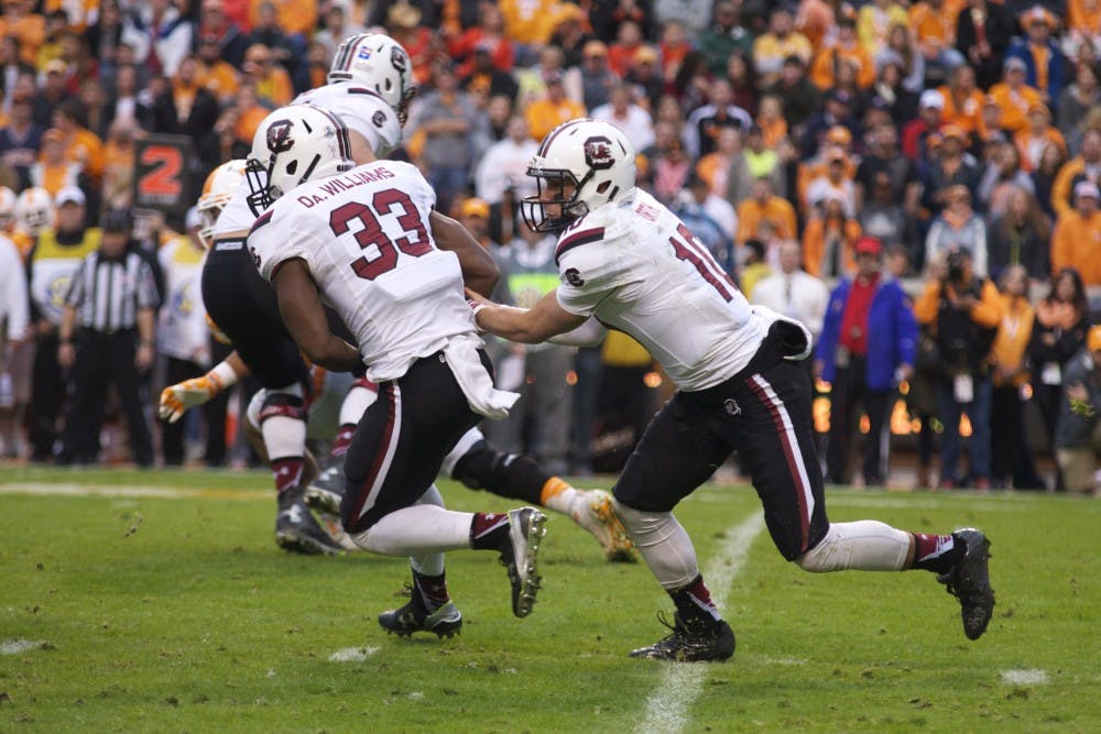 <p>David Williams takes a handoff from Perry Orth in South Carolina's 27-24 loss to Tennessee on Nov. 7.</p>