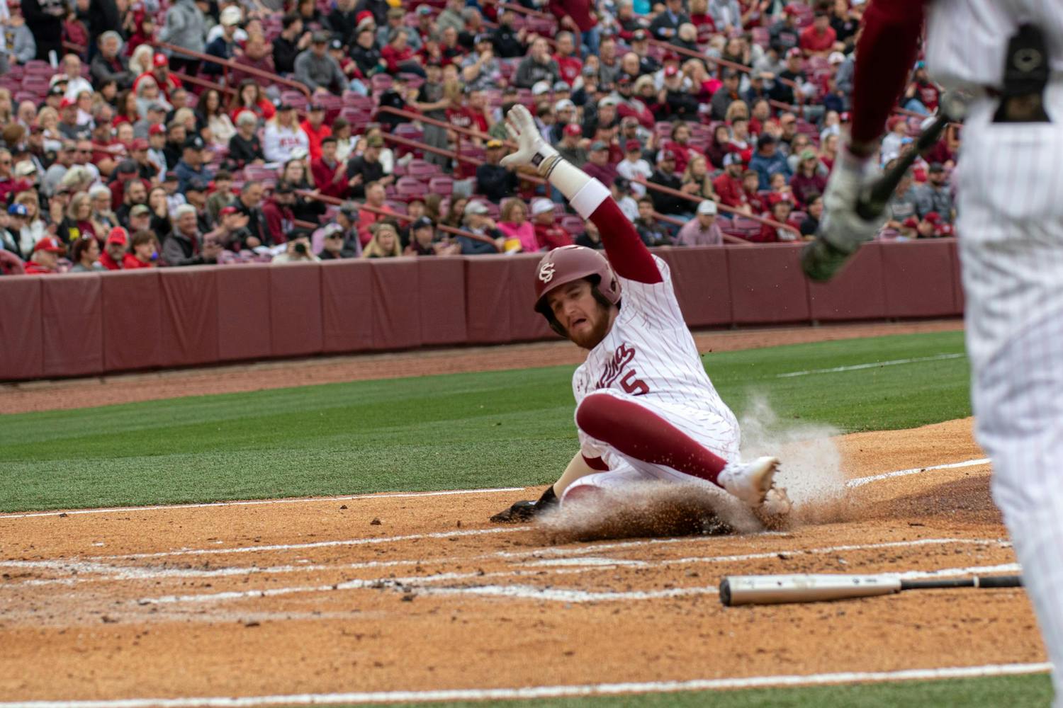 Junior third baseman Talmadge LeCroy slides into home plate on Feb. 16, 2024 at Founders Park. LeCroy had one hit during the Gamecocks' first victory over Miami-Ohio.