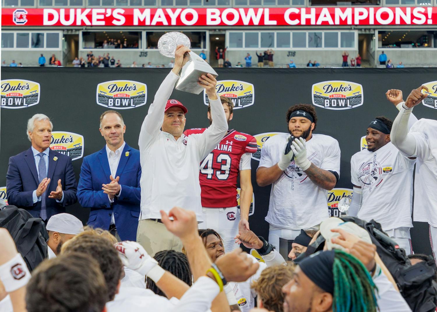 FILE—Head coach Shane Beamer holds up the Duke's Mayo Bowl Trophy on Dec. 30, 2022. The Gamecocks beat North Carolina 38-21.