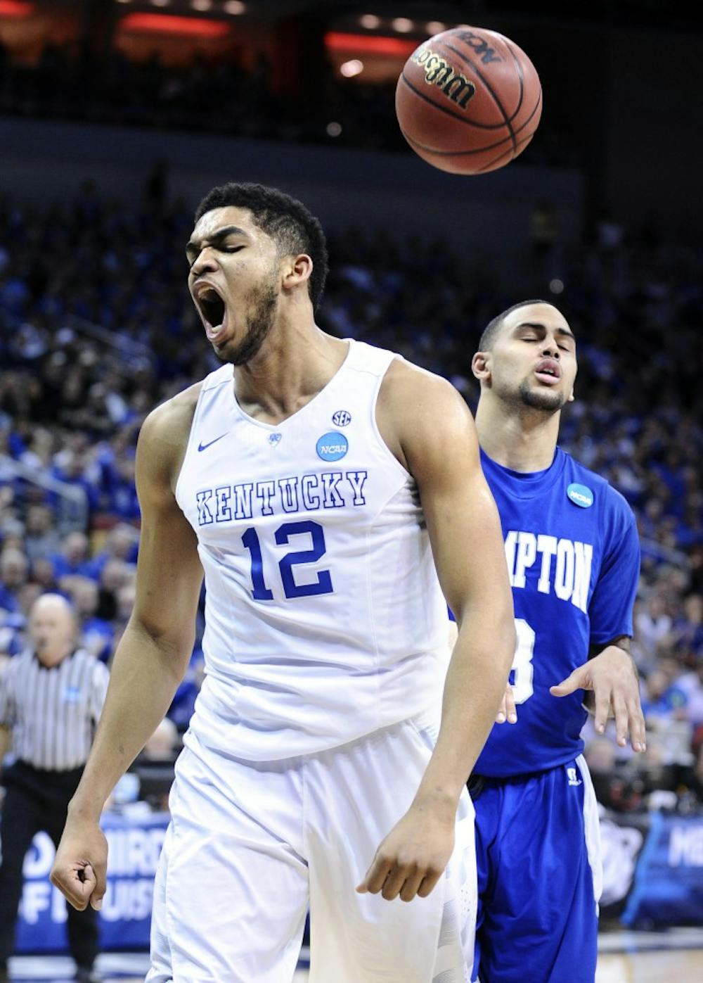 Kentucky's Karl-Anthony Towns (12) celebrates after scoring and being fouled by Hampton's Quinton Chievous in the second round of the NCAA Tournament at the KFC Yum! Center in Louisville, Ky., on Thursday, March 19, 2015. (Wally Skalij/Los Angeles Times/TNS)