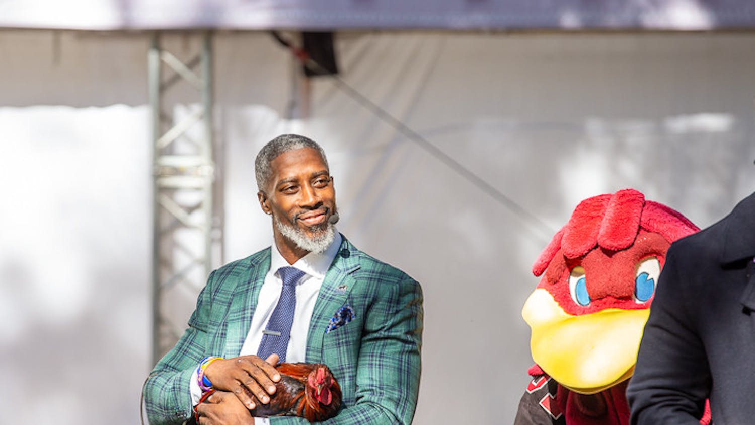 Roman Harper pets Sir Big Spur at the end of the SEC Nation morning show on Nov. 19, 2022. Harper played safety for Alabama and the New Orleans Saints.